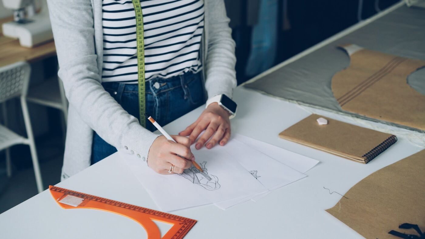 designer working logo sketches computer screen
