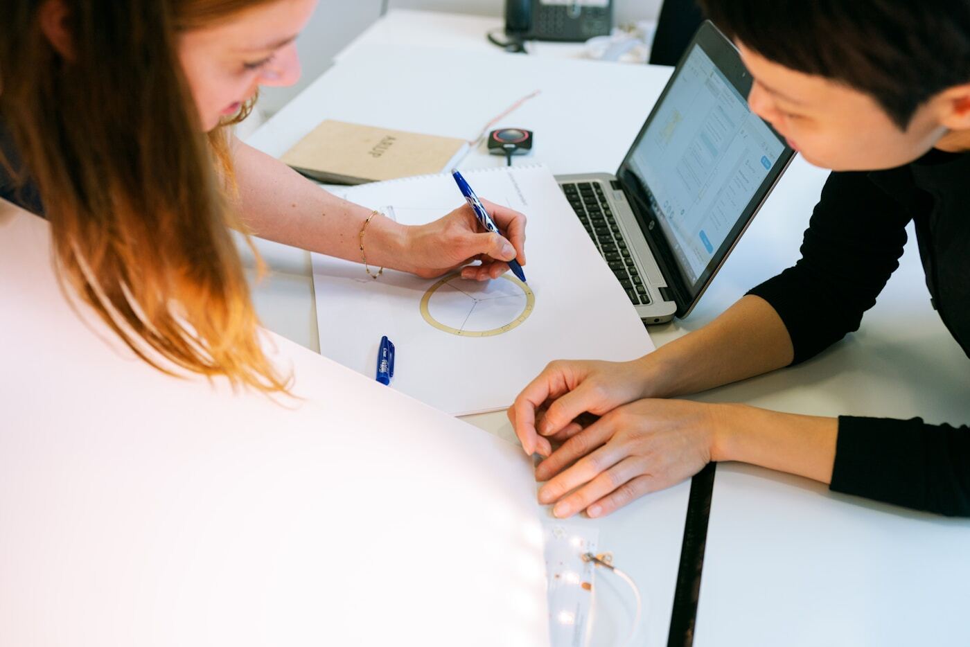 marketing team reviewing webinar analytics dashboard laptop